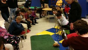 The students watch captivated by the wild armadillo.