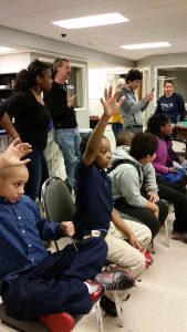 Students raising their hands to ask a question